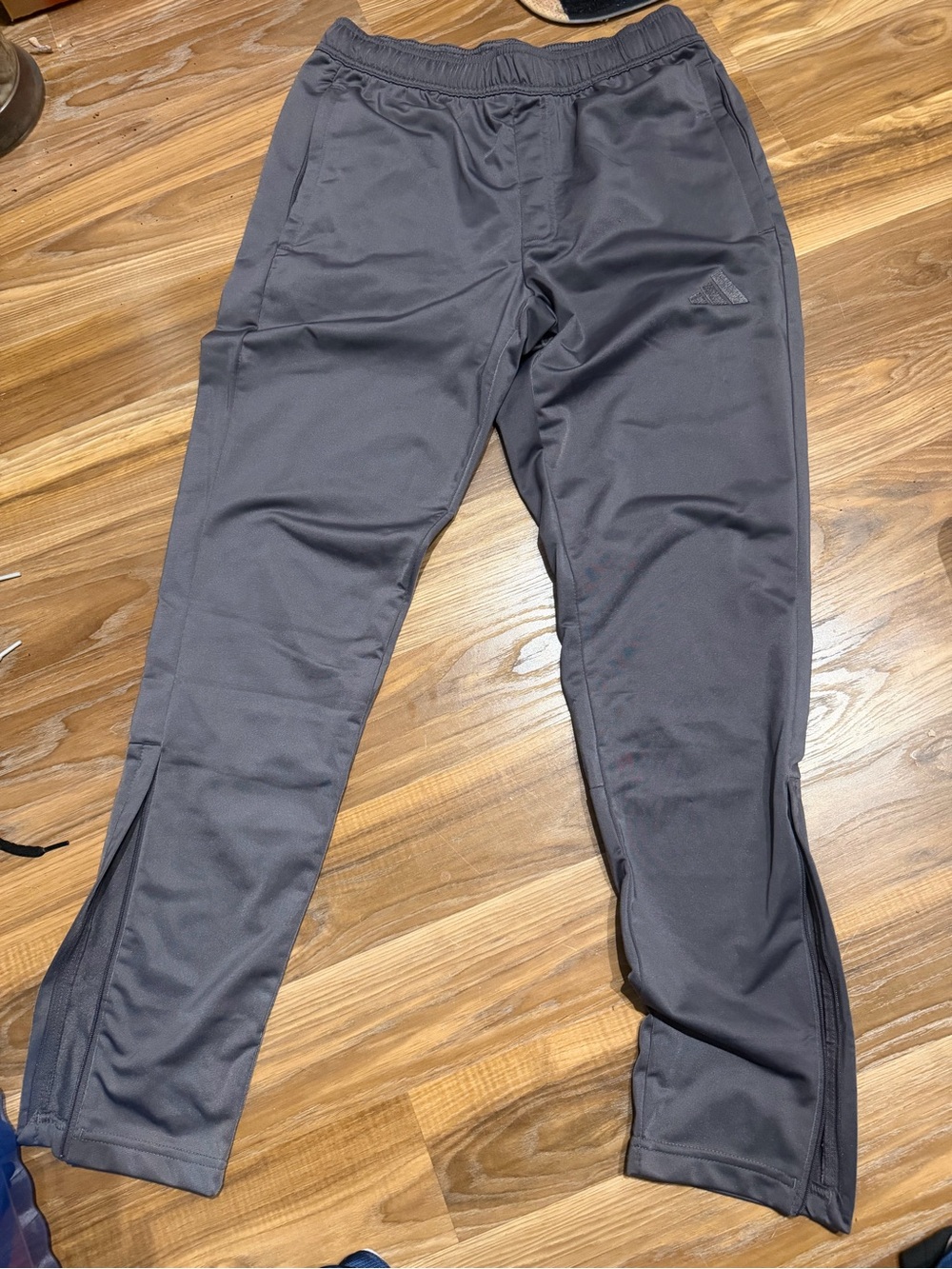 Grey Adidas track pants.